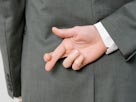 Image: Dishonest man (Â© Halfdark/fStop/Getty Images)